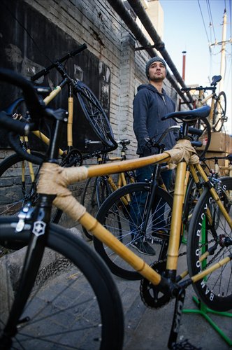 David Chin-Fei Wang stands next to bamboo bikes made in the workshops. Photo: Li Hao/GT