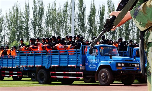 Authorities in Ili prefecture, Xinjiang Uyghur Autonomous Region hold a public hearing Tuesday at a stadium to pronounce sentences for 55 involved in terrorist activities. Photo: China News Service