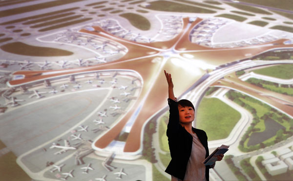 An artist's impression of the new Beijing airport is shown at a ceremony in Beijing on Wednesday. By the time the airport is operational, the capital will be able to handle at least 100 million air passengers a year. ZOU HONG / CHINA DAILY   
