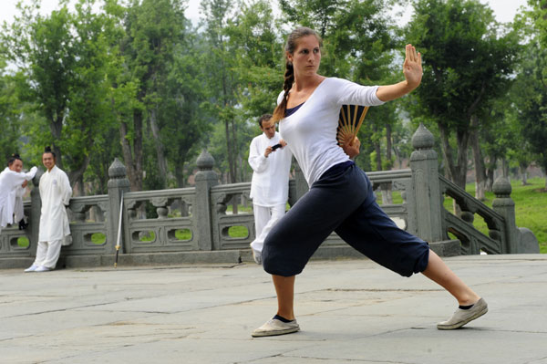 A student practices Taoist kung fu in the Jade Void Palace at Wudang Mountain, Hubei province. Wudang, long known as an important center of Taoism, has recently attracted a growing number of enthusiasts from all over the world. HE TONGQIAN/XINHUA