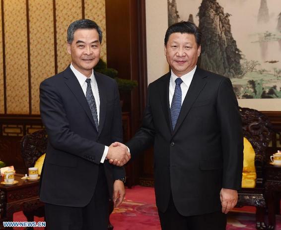 Chinese President Xi Jinping (R) meets with Hong Kong Special Administrative Region Chief Executive Leung Chun-ying in Beijing, capital of China, Dec. 26, 2014. Leung is in Beijing to report his work to the central government. (Xinhua/Rao Aimin)