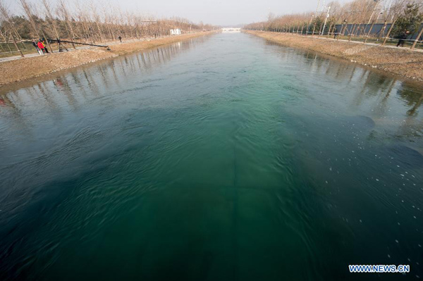 Photo taken on Dec 27, 2014 shows water flowing after the opening of a sluice gate of the middle route of the south-to-north water diversion project in Beijing, capital of China. (Xinhua/Zhang Yu)