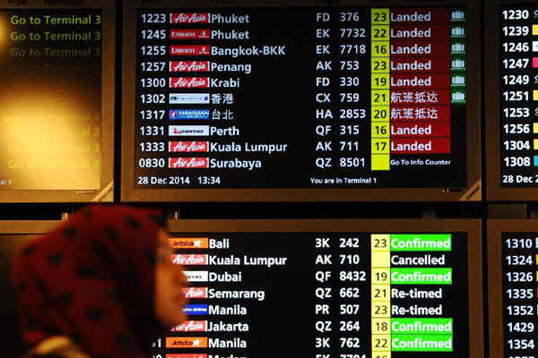 Picture taken on Dec 28, 2014 shows the arrival information board displaying the status of Air Asia flight QZ8501 at Changi Airport in Singapore. The flight QZ8501 took off from Surabaya, Indonesia, at 5:20 am local time and was scheduled to arrive at Singapore's Changi Airport at 8:30 am. Singapore air traffic control was informed at 7:54 am that the flight lost contact with Jakarta air traffic control at 7:24 am local time on Sunday. (Xinhua/Then Chih Wey)