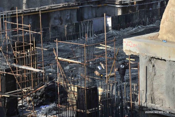 Photo taken on Dec. 29. 2014 shows the construction site where a scaffold collapsed in the Tsinghua High School in Beijing, China. Ten people were killed and four were injured following the scaffold collapse in the school on Monday morning, local sources said. The injured were all rushed to the nearby hospital. Rescue work is under way. (Xinhua/Li Wen) 