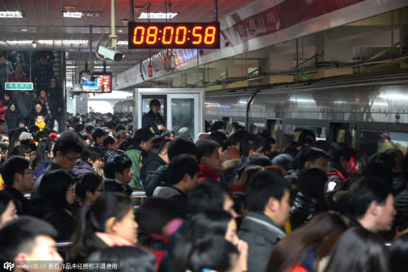 Passengers wait to board a train of subway Line One at a station in Beijing, Dec 29, 2014. Beijing has raised subway fares from Dec 28, but it seems to make little difference to the congestion on the public transport system. The city's subway system carries approximately 10 million passengers daily on workdays. [Photo/CFP] 