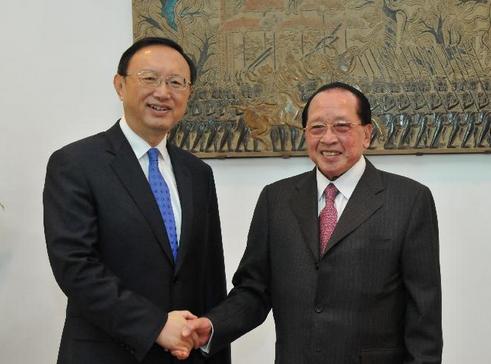 Cambodian Deputy Prime Minister and Foreign Minister Hor Namhong (R) shakes hands with visiting Chinese State Councilor Yang Jiechi in Phnom Penh, Cambodia, Dec. 30, 2014. The second meeting of the Cambodia-China Inter-Governmental Coordination Committee kicked off here in the capital of Cambodia on Tuesday with an aim of deepening the comprehensive strategic partnership of cooperation between the two nations. (Xinhua/Li Hong)