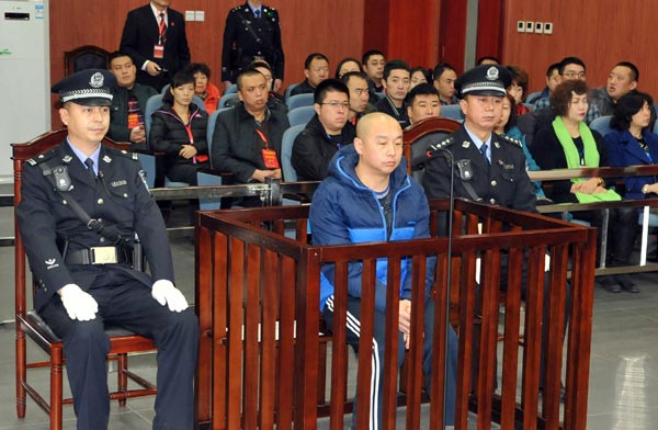 Zhao Zhihong (center) stands trial at Hohhot Intermediate People's Court in North China's Inner Mongolia autonomous region Monday. [Photo provided to China Daily]  