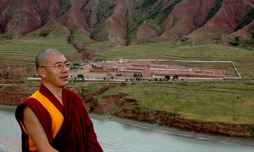 Above left: Headmaster Jigme stands on the bank of the Yellow River. Across the river is the overview of the whole school. Photo: Courtesy of Jigme Gyaltsen Welfare School