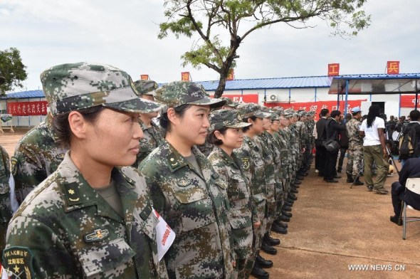 Chinese soldiers stand at attention at the opening ceremony of the Ebola treatment center in Monrovia on Nov 25, 2014. China opened a 100-bed treatment center in Liberia on Tuesday. (Xinhua/Dai Chunyong) 