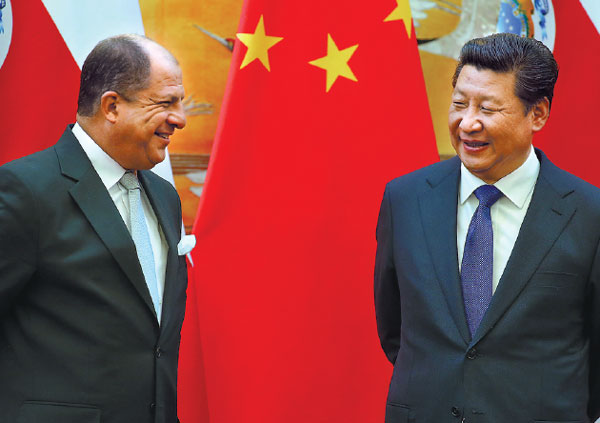 President Xi Jinping talks with Costa Rican President Luis Guillermo Solis at the Great Hall of the People in Beijing on Tuesday. The leaders witnessed the signing of a series of agreements between the countries. Wu Zhiyi / China Daily