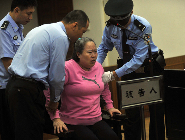 Ding Yuxin, a Shanxi businesswoman whose original name is Ding Shumiao, appears in a Beijing court in September 2013. She was sentenced in December to 20 years in prison for paying bribes to the exrailways minister to get business illegally. [Photo/Xinhua]  