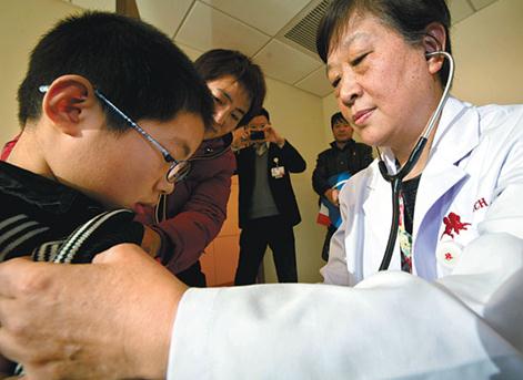 A doctor examines a child at a private hospital in Tianjin. In China, doctors at public hospitals are usually full-time employees, but things are changing after the government introduced policies to encourage doctors to move into the private sector. Yue Yuewei / Xinhua  