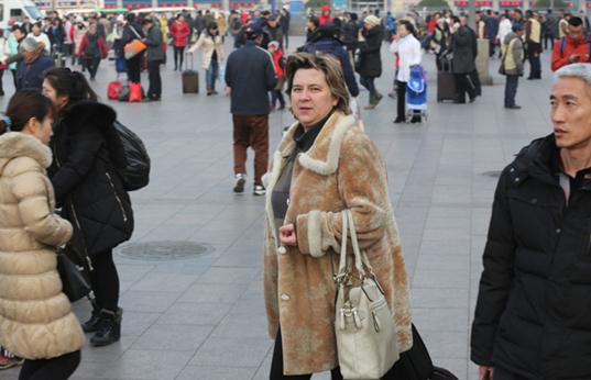 Foreigners traveling by train during the upcoming Spring Festival rush will face extra delays because they must have their IDs checked and buy their tickets at counters rather than from ticket machines. WANG JING / CHINA DAILY  