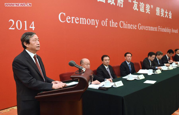 Chinese Vice Premier Ma Kai (1st L) addresses the ceremony of the Chinese Government Friendship Award in Beijing, capital of China, Sept. 29, 2014. The Friendship Award is an annual award issued by the Chinese government to honor outstanding foreign experts in China. [Photo/Xinhua]