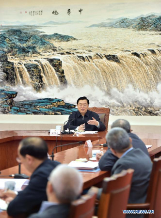 Zhang Dejiang (rear), chairman of China's Standing Committee of the National People's Congress (NPC), presides over a symposium with some NPC delegates in Beijing to listen to their advices on the draft of the work report of the NPC Standing Committee on Tuesday. (Xinhua/Li Tao) 
