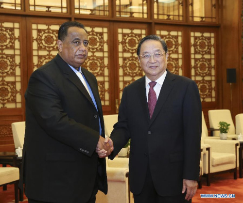 Yu Zhengsheng(R), chairman of the National Committee of the Chinese People's Political Consultative Conference, meets with the deputy chairman of Sudan's ruling National Congress Party (NCP) Ibrahim Ghandour, who is also assistant to the Sudanese President Omar al-Bashir, in Beijing, capital of China, Jan. 28, 2015. Ghandour is visiting China to attend the third high-level dialogue between the Communist Party of China and the Sudan's National Congress Party (NCP). (Xinhua/Ding Lin)