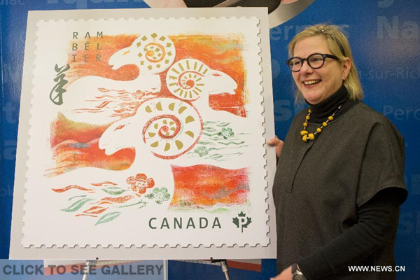 Designer Helene L'Heureux poses for photos with her stamp design at a post office in Toronto, Canada, Jan 8, 2015. Canada Post issued Year of the Goat domestic and international rate stamps and collectibles on Thursday in celebration of the upcoming Chinese Lunar Year of the Goat. (Xinhua/Zou Zheng) 