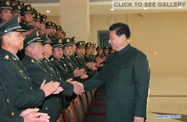 Chinese President Xi Jinping (R), also general secretary of the Communist Party of China (CPC) Central Committee and chairman of the Central Military Commission, meets with senior officers of the 14th army group in Kunming, capital city of southwest China's Yunnan province, Jan 21, 2015. (Xinhua/Li Gang) 