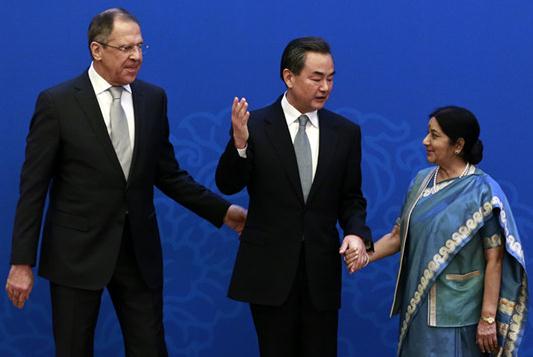 Foreign Minister Wang Yi (center) meets with his Indian counterpart Sushma Swaraj (right) and Russian Foreign Minister Sergei Lavrov in Beijing on Monday for a regular trilateral meeting among the foreign ministers of the three countries. FENG YONGBIN / CHINA DAILY  
