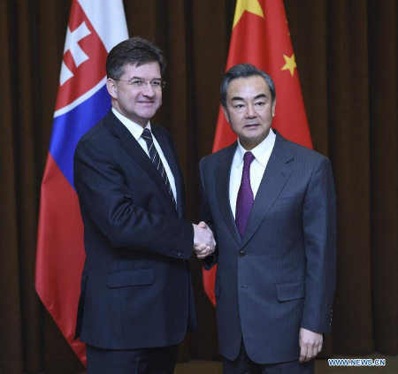 Chinese Foreign Minister Wang Yi (R) holds talks with Slovakia's Deputy Prime Minister and Minister of Foreign and European Affairs Miroslav Lajcak in Beijing, capital of China, Feb. 4, 2015. (Xinhua/Zhang Duo)