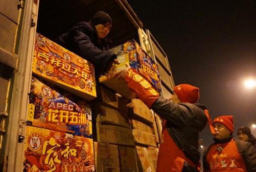 Staff workers of a fireworks company transport its products in Haidian district in Beijing on Tuesday. Firecrackers sales will begin on Feb 13 and lasts for 10 days. Cao Boyuan / for China Daily  