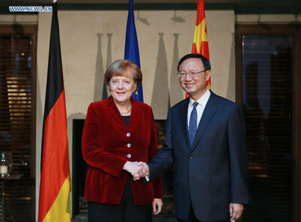 Chinese State Councilor Yang Jiechi (R) meets with German Chancellor Angela Merkel in Munich, Germany, on Feb.7, 2015. (Xinhua/Luo Huanhuan)