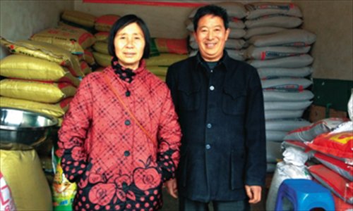 Zou Yuhua (left) and Zhang Mingfa pose in their feed store on January 26. Photo: The Beijing News