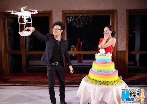 Wang Feng takes an engagement ring from a basket, delivered by drone. [Photo/Xinhua]