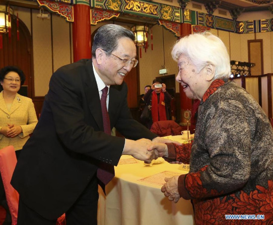 Yu Zhengsheng (L), chairman of the National Committee of Chinese People's Political Consultative Conference (CPPCC), attends a New Year gathering held by the CPPCC National Committee for spouses of some late renowned social figures and national political advisors who were not members of the Communist Party of China (CPC) , in Beijing, China, Feb. 10, 2015. (Xinhua/Ding Lin)