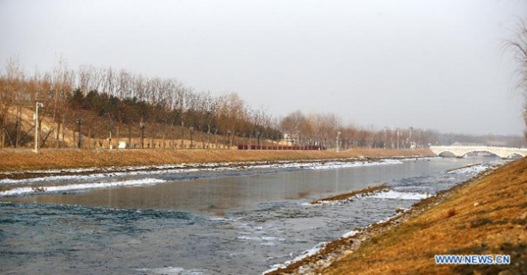 Photo taken on Dec 27, 2014 shows water flowing after the opening of a sluice gate of the middle route of the south-to-north water diversion project in Beijing, capital of China. (Xinhua/Yin Gang)