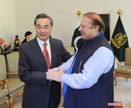 Pakistani Prime Minister Nawaz Sharif (R) shakes hands with visiting Chinese Foreign Minister Wang Yi in Islamabad, Pakistan, on Feb. 13, 2015. Pakistan and China vowed to expedite work on the China-Pakistan Economic Corridor during a meeting between Pakistani Prime Minister Nawaz Sharif and visiting Chinese Foreign Minister Wang Yi here on Friday. (Xinhua/Huang Zongzhi)