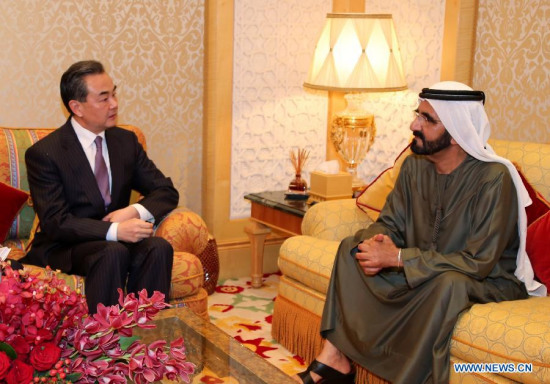The United Arab Emirates (UAE) Vice President, Prime Minister and Dubai ruler Sheikh Mohammed Bin Rashid Al-Maktoum (R) meets with Chinese Foreign Minister Wang Yi in Dubai, the United Arab Emirates, on Feb. 14, 2015. UAE would like to serve as the gateway to better ties between China and the countries in the Gulf region and the Arab world, a senior UAE official said on Saturday. (Xinhua/Li Zhen)