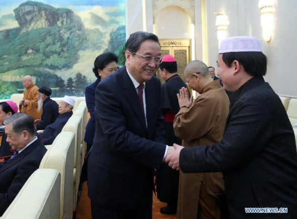 Yu Zhengsheng (L front), chairman of the National Committee of the Chinese People's Political Consultative Conference, talks with leaders of major national religious groups during a gathering to celebrate the upcoming Spring Festival, in Beijing, China, Feb. 15, 2015. (Xinhua/Liu Weibing)