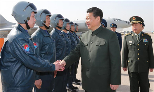 General Secretary of the Communist Party of China Central Committee and Chinese President Xi Jinping (R front), also chairman of the Central Military Commission, shakes hands with crew members of air force during his inspection of the armed forces in Xi'an, northwest China's Shaanxi Province, Feb. 16, 2015. Xi extended Spring Festival greetings to all those in service nationwide. (Photo: Xinhua/Li Gang)
