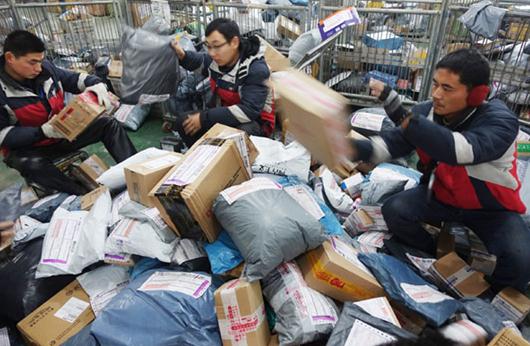 The period before Spring Festival is one of the busiest for couriers. [Photo by Wang Biao/For China Daily]