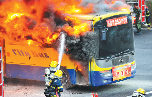 Firefighters combat a fire on a bus during a drill in Chongqing, Southwest China. (Photo: Xinhua/Liu Chan)