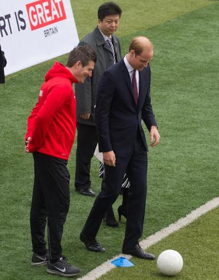Britain's Prince William visits a soccer training camp at Nanyang High School in Shanghai on Tuesday. (Photo: for China Daily/Gao Erqiang)