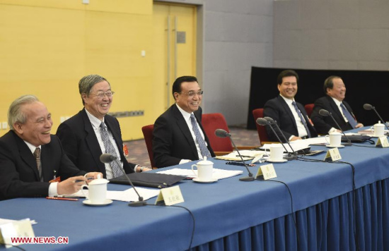 Chinese Premier Li Keqiang (C), who is also a member of the Standing Committee of the Political Bureau of the Communist Party of China (CPC) Central Committee, visits members of the 12th National Committee of the Chinese People's Political Consultative Conference (CPPCC) from the economic and agricultural circles and joins their panel discussion in Beijing, capital of China, March 4, 2015. (Xinhua/Li Xueren)