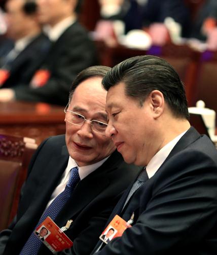 President Xi Jinping talks with Wang Qishan, head of the Central Commission for Discipline Inspection, at a preparatory meeting for the third session of the 12th National People's Congress in Beijing on Wednesday.(Photo: China Daily/Wu Zhiyi)