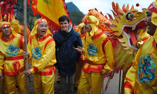 Nikolas Jaspert (middle), a volunteer teacher from Germany, poses at a local festival in Gongcheng Yao Autonomous County in Guangxi Zhuang Autonomous Region. (Photo: Courtesy of Jaspert)