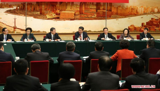 Chinese President Xi Jinping (back, C), also general secretary of the Communist Party of China (CPC) Central Committee and chairman of the Central Military Commission, joins a panel discussion of deputies to the 12th National People's Congress (NPC) from east China's Shanghai, in Beijing, capital of China, March 5, 2015. (Xinhua/Huang Jingwen)