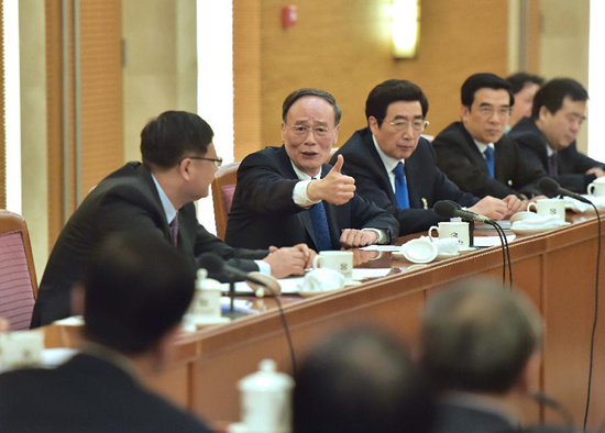 Wang Qishan (back, 2nd L), a member of the Standing Committee of the Political Bureau of the Communist Party of China (CPC) Central Committee and secretary of the CPC Central Commission for Discipline Inspection, joins a panel discussion of deputies to the 12th National People's Congress (NPC) from Beijing, in Beijing, capital of China, March 5, 2015. (Xinhua/Li Tao)