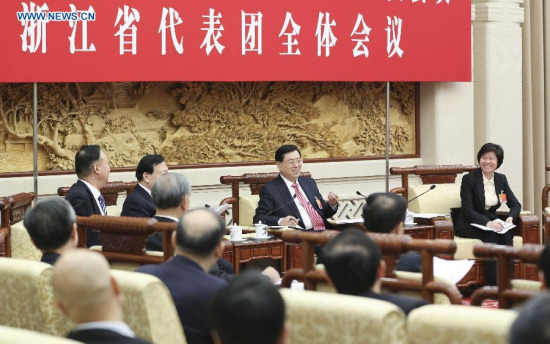 Zhang Dejiang(back, 2nd R), chairman of the Standing Committee of China's National People's Congress (NPC) and a member of the Standing Committee of the Political Bureau of the Communist Party of China (CPC) Central Committee, joins a panel discussion of deputies to the 12th NPC from east China's Zhejiang Province, in Beijing, capital of China, March 5, 2015. (Xinhua/Ding Lin)