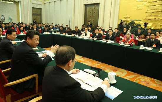 Chinese President Xi Jinping (front, 2nd R), also general secretary of the Communist Party of China (CPC) Central Committee and chairman of the Central Military Commission, reviews the work report of the State Council together with National People's Congress (NPC) deputies from Jiangxi Province during the third session of the 12th NPC, in Beijing, capital of China, March 6, 2015. (Xinhua/Lan Hongguang)