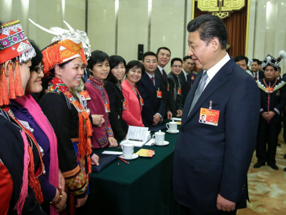 President Xi Jinping talks to female deputies from Guangxi on Sunday, sending International Womens Day greetings to them as well as all women across the country. (Photo: Xinhua/Lan Hongguang)