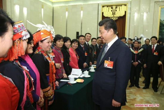 Chinese President Xi Jinping (front R), also general secretary of the Communist Party of China (CPC) Central Committee and chairman of the Central Military Commission, greets female deputies for the International Women's Day at a panel discussion with deputies to the 12th National People's Congress (NPC) from south China's Guangxi Zhuang Autonomous Region during the third session of the 12th NPC, in Beijing, capital of China, March 8, 2015. (Xinhua/Lan Hongguang)