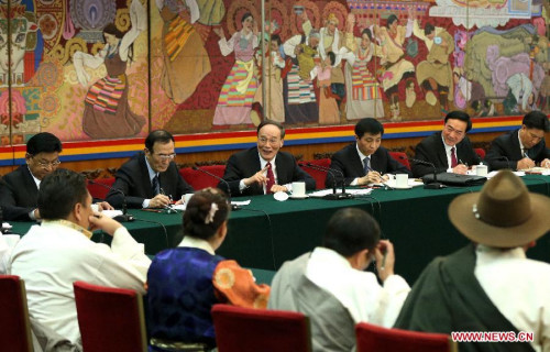 Wang Qishan (back, 3rd L), a member of the Standing Committee of the Political Bureau of the Communist Party of China (CPC) Central Committee and secretary of the CPC Central Commission for Discipline Inspection, joins a panel discussion with deputies to the 12th National People's Congress (NPC) from southwest China's Tibet Autonomous Region during the third session of the 12th NPC, in Beijing, capital of China, March 12, 2015. (Xinhua/Ma Zhancheng)