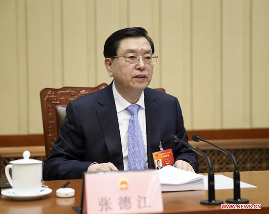 Zhang Dejiang, executive chairperson of the presidium of the third session of China's 12th National People's Congress (NPC), presides over the third meeting of the presidium at the Great Hall of the People in Beijing, capital of China, March 14, 2015. (Xinhua/Lan Honggguang)