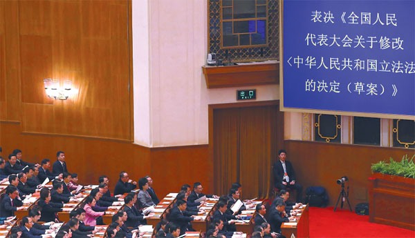 The amendment to the Legislation Law, the cornerstone of China's legal system, is ratified at the closing session of this year's National People's Congress on Sunday. As part of a process of ongoing legal reform, the amendment is intended to remove ambiguous language and legal definitions, streamline the lawmaking process, and further tighten the administration of the law. (Pang Xinglei/Xinhua)