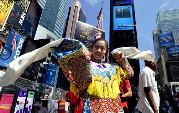 An artist promotes Peking Opera at Times Square in New York City in August. China's national image is improving, a recent survey found. (Photo: China Daily/Wang Lei)